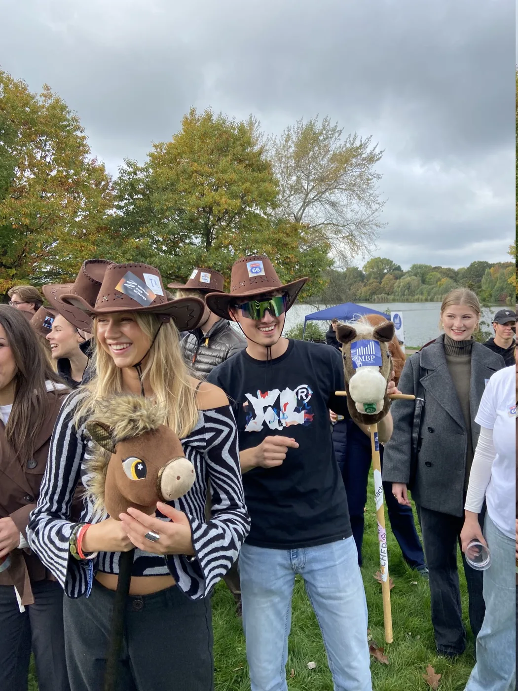 Zwei Mitglieder der O-Gruppe mit Cowboyhüten und Steckenpferd